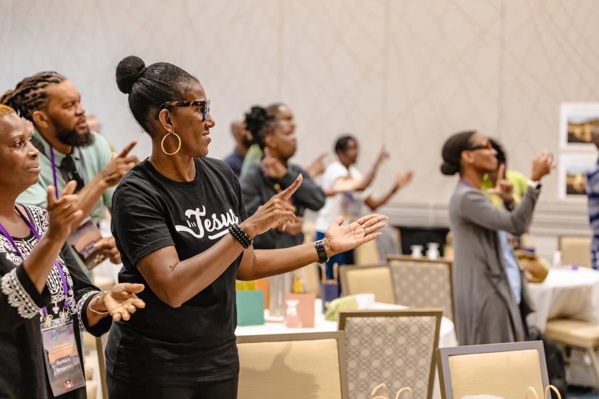 Group of people using sign language at the SLAm! 43 Conference in Barbados.